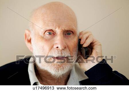 Stock Image - Older man talking on cell phone. Fotosearch