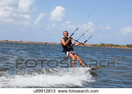 Older man wind surfing on lake View Large Photo Image Stock Image - Older man wind surfing on lake. Fotosearch