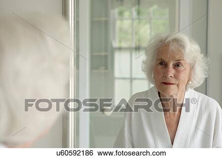 Older woman admiring herself in mirror View Large Photo Image Stock Photograph - Older woman admiring herself in mirror. Fotosearch