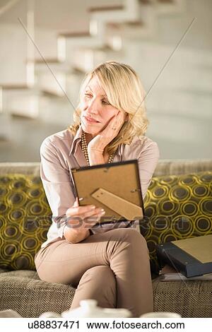 Older woman holding framed photo View Large Photo Image Stock Image - Older woman holding framed photo. Fotosearch