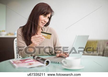 Older woman shopping online View Large Photo Image Stock Image - Older woman shopping online. Fotosearch