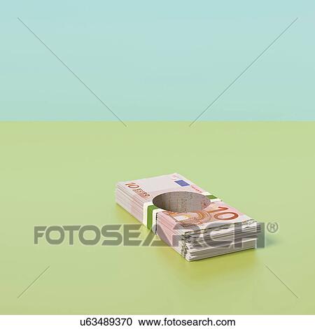 Stock Image - Pile of Euro notes with hole through the middle. Fotosearch