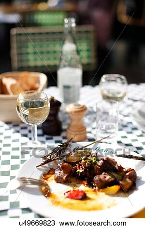Stock Image - Plate of food at table outdoors. Fotosearch