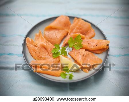 Stock Image - Plate of hand reared Scottish smoked salmon. Fotosearch
