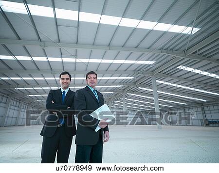 Stock Photo - Portrait of property managers in finished factory building. Fotosearch