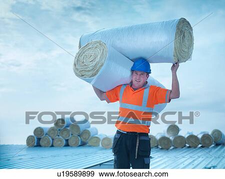 Portrait of workman carrying rolls of insulation to install into factory roof View Large Photo Image Stock Photo - Portrait of workman carrying rolls of insulation to install into factory roof. Fotosearch