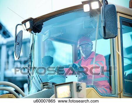 Portrait of workman driving industrial digger on quarry site View Large Photo Image Stock Photography - Portrait of workman driving industrial digger on quarry site. Fotosearch