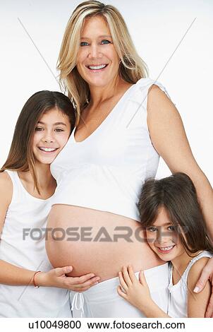 Pregnant mother hugging daughters View Large Photo Image Stock Image - Pregnant mother hugging daughters. Fotosearch