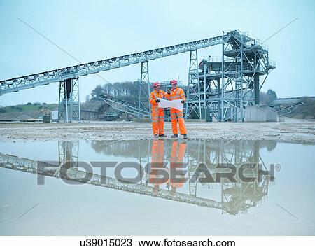 Quarryman and assistant looking at plans in front of quarry screening plant View Large Photo Image Stock Image - Quarryman and assistant looking at plans in front of quarry screening plant. Fotosearch