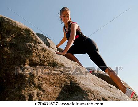 Rock climber scaling rock face View Large Photo Image Stock Photo - Rock climber scaling rock face. Fotosearch