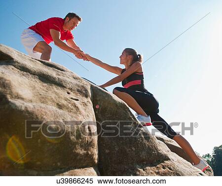 Rock climbers helping each other View Large Photo Image Stock Photography - Rock climbers helping each other. Fotosearch