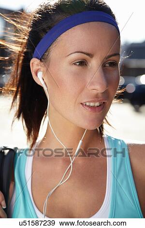 Stock Photo - Runner listening to headphones. Fotosearch