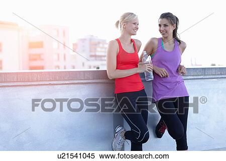 Runners talking on rooftop View Large Photo Image Stock Photography - Runners talking on rooftop. Fotosearch