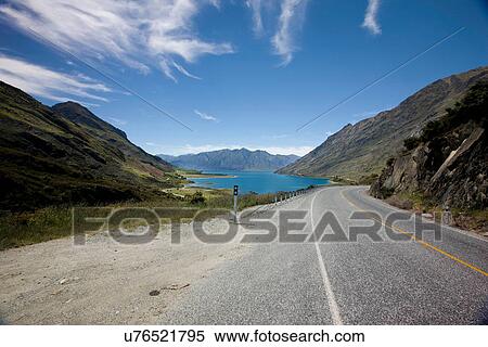 Stock Photography - Rural road winding through mountains. Fotosearch