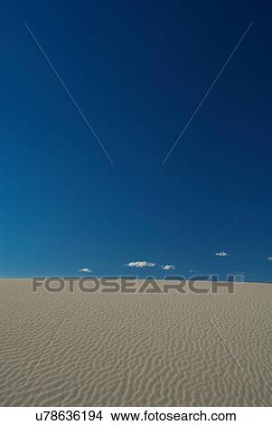 Sand dune under blue sky View Large Photo Image Picture - Sand dune under blue sky. Fotosearch