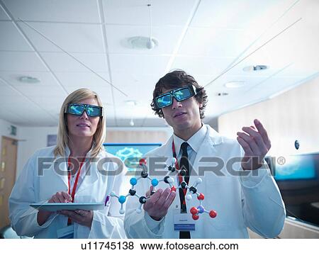 Scientist and apprentice in 3D glasses holding molecular model and digital tablet View Large Photo Image Stock Photo - Scientist and apprentice in 3D glasses holding molecular model and digital tablet. Fotosearch