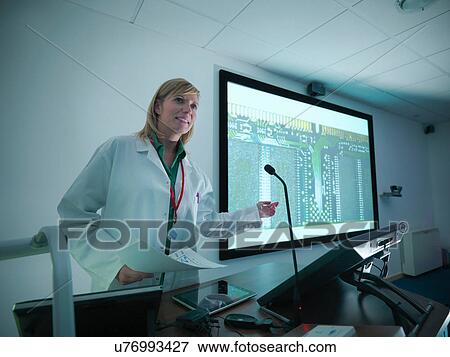 Scientist using presentation on smart board for lecture View Large Photo Image Stock Photo - Scientist using presentation on smart board for lecture. Fotosearch