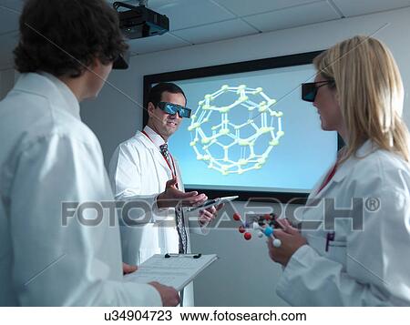 Scientists and apprentice in 3D glasses in meeting in front of molecular model on 3D screen View Large Photo Image Stock Image - Scientists and apprentice in 3D glasses in meeting in front of molecular model on 3D screen. Fotosearch