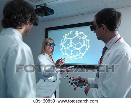Scientists and apprentice in 3D glasses in meeting in front of molecular model on 3D screen View Large Photo Image Stock Photo - Scientists and apprentice in 3D glasses in meeting in front of molecular model on 3D screen. Fotosearch