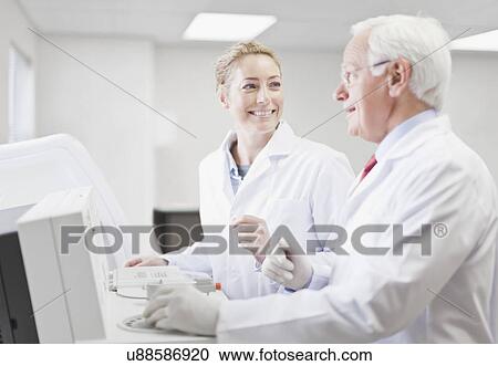 Stock Image - Scientists working in pathology lab. Fotosearch