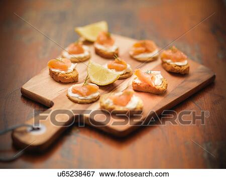 Scottish smoked salmon and cream cheese canapes on board View Large Photo Image Stock Photo - Scottish smoked salmon and cream cheese canapes on board. Fotosearch