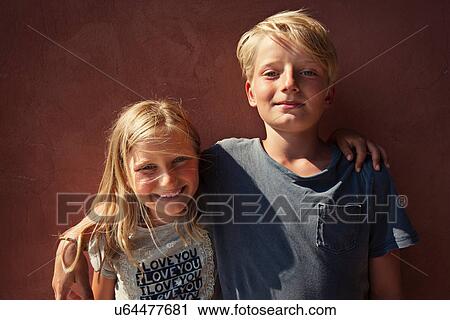 Siblings smiling together outdoors View Large Photo Image Stock Image - Siblings smiling together outdoors. Fotosearch