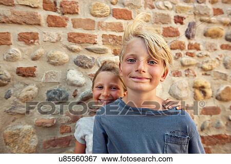 Siblings smiling together outdoors View Large Photo Image Stock Photo - Siblings smiling together outdoors. Fotosearch