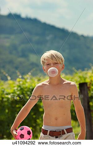 Smiling boy blowing bubble outdoors View Large Photo Image Stock Image - Smiling boy blowing bubble outdoors. Fotosearch
