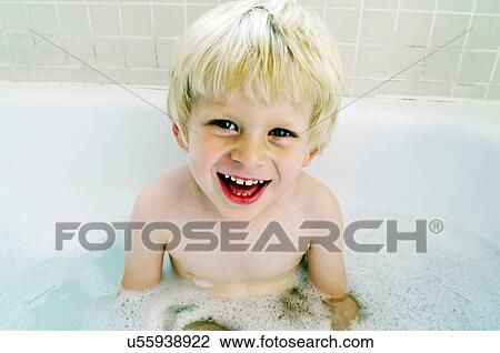 Smiling boy sitting in bath View Large Photo Image Stock Image - Smiling boy sitting in bath. Fotosearch