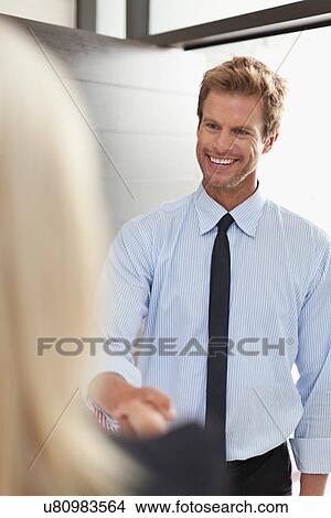 Smiling business people shaking hands View Large Photo Image Picture - Smiling business people shaking hands. Fotosearch