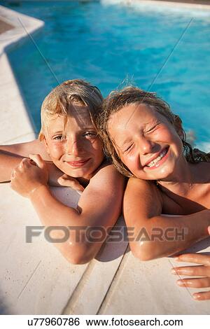 Stock Photograph - Smiling children in swimming pool. Fotosearch