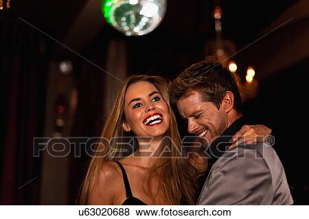 Smiling couple dancing in club View Large Photo Image Stock Photo - Smiling couple dancing in club. Fotosearch