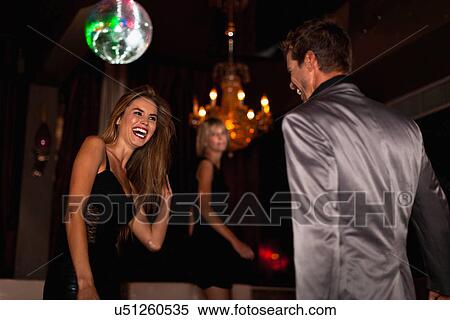 Stock Photography - Smiling couple dancing in club. Fotosearch