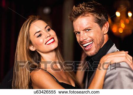 Stock Photography - Smiling couple dancing in club. Fotosearch