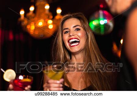 Smiling couple having cocktails in club View Large Photo Image Stock Photography - Smiling couple having cocktails in club. Fotosearch