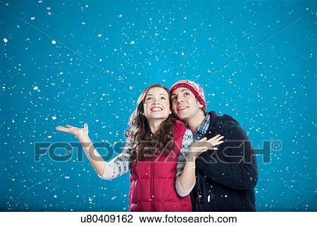 Smiling couple hugging in snow View Large Photo Image Stock Image - Smiling couple hugging in snow. Fotosearch