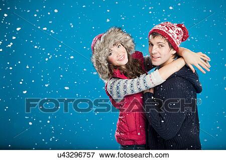 Smiling couple hugging in snow View Large Photo Image Stock Photo - Smiling couple hugging in snow. Fotosearch