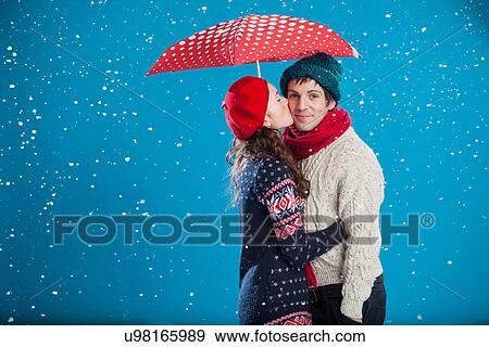 Smiling couple kissing in snow View Large Photo Image Stock Photo - Smiling couple kissing in snow. Fotosearch