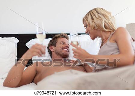 Smiling couple toasting each other View Large Photo Image Stock Image - Smiling couple toasting each other. Fotosearch