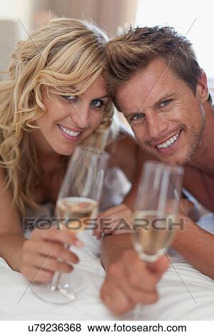 Smiling couple toasting each other View Large Photo Image Stock Photo - Smiling couple toasting each other. Fotosearch