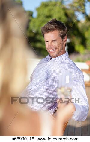Smiling couple toasting each other View Large Photo Image Stock Photography - Smiling couple toasting each other. Fotosearch