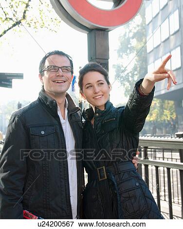 Stock Photo - Smiling couple walking on city street. Fotosearch