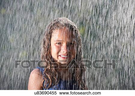 Smiling girl playing in rain View Large Photo Image Stock Photography - Smiling girl playing in rain. Fotosearch