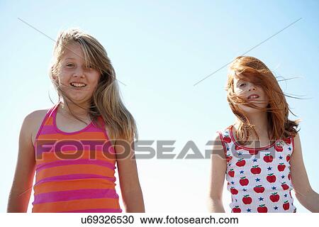 Smiling girls hair blowing in wind View Large Photo Image Stock Image - Smiling girls hair blowing in wind. Fotosearch