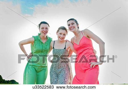 Smiling girls hugging outdoors View Large Photo Image Stock Image - Smiling girls hugging outdoors. Fotosearch