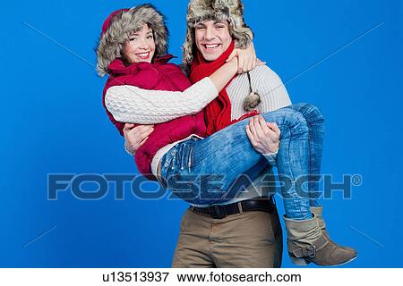 Smiling man carrying girlfriend View Large Photo Image Stock Photo - Smiling man carrying girlfriend. Fotosearch