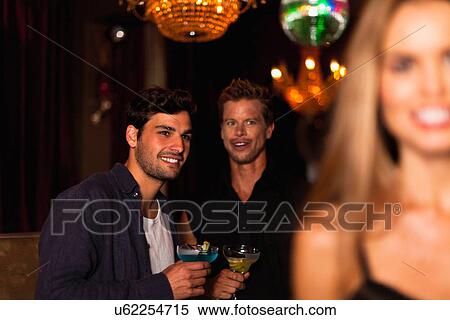 Smiling men having cocktails in club View Large Photo Image Stock Photography - Smiling men having cocktails in club. Fotosearch