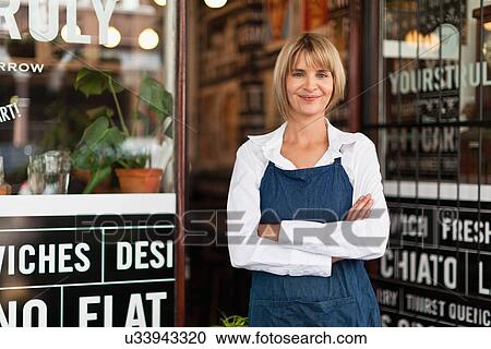 Smiling waitress standing in cafe View Large Photo Image Stock Image - Smiling waitress standing in cafe. Fotosearch