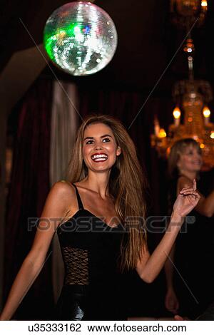 Smiling woman dancing in club View Large Photo Image Stock Image - Smiling woman dancing in club. Fotosearch