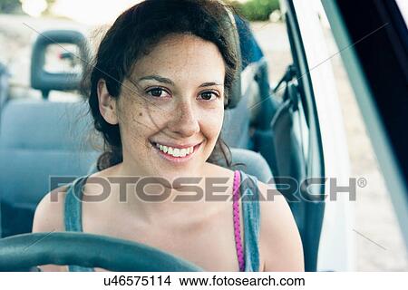 Picture - Smiling woman driving car. Fotosearch